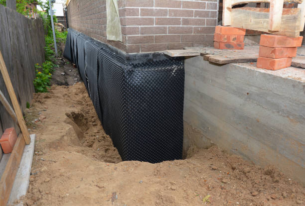 SJ Waterproofing Pros technician performing targeted Basement Waterproofing assessment in Ferrysburg, MI
